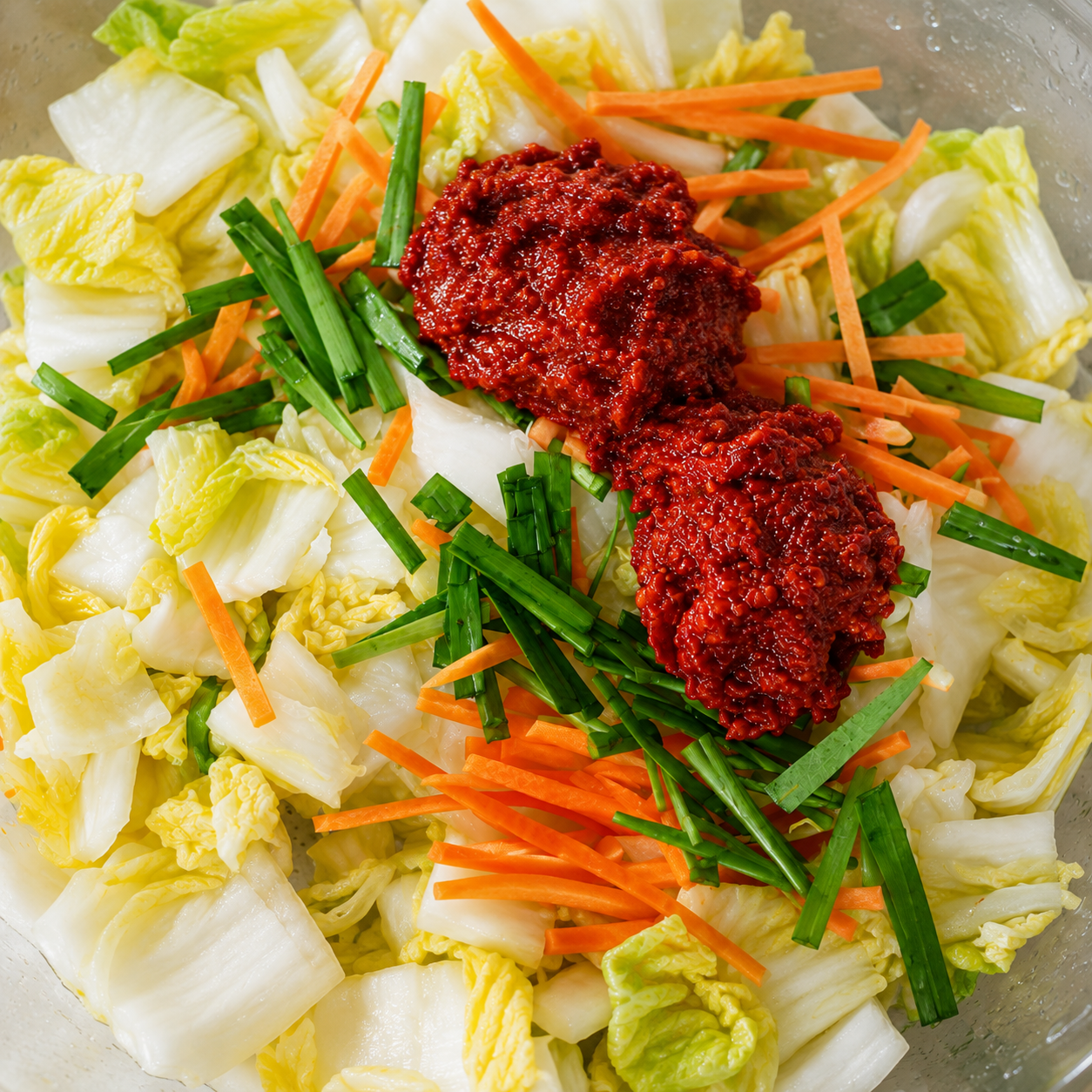 Adding Kimchi Drop paste to wombok